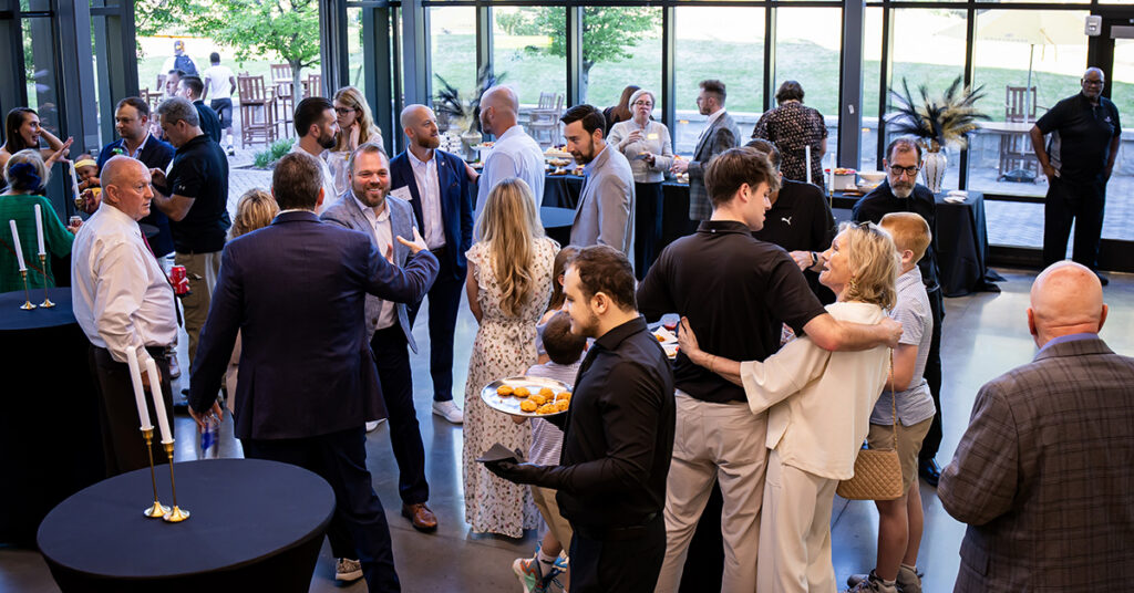 Alumni, faculty, and staff mingle in Cousins Center for the Alumni Awards and Athletics Hall of Fame Reception.