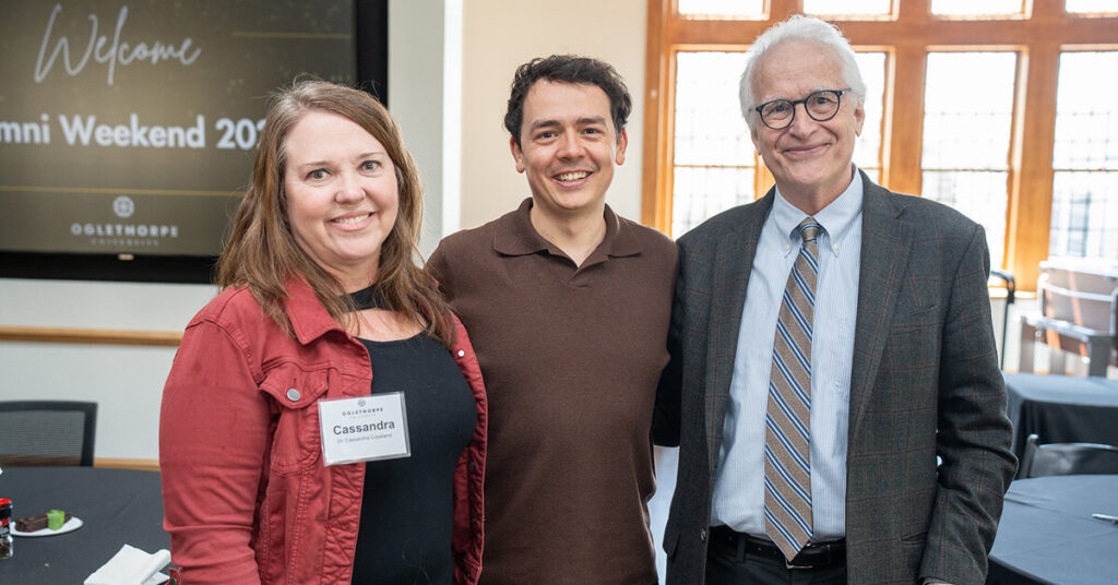 Dr. Copeland and Dr. Kower pose with an alumnus in Lupton Auditorium.