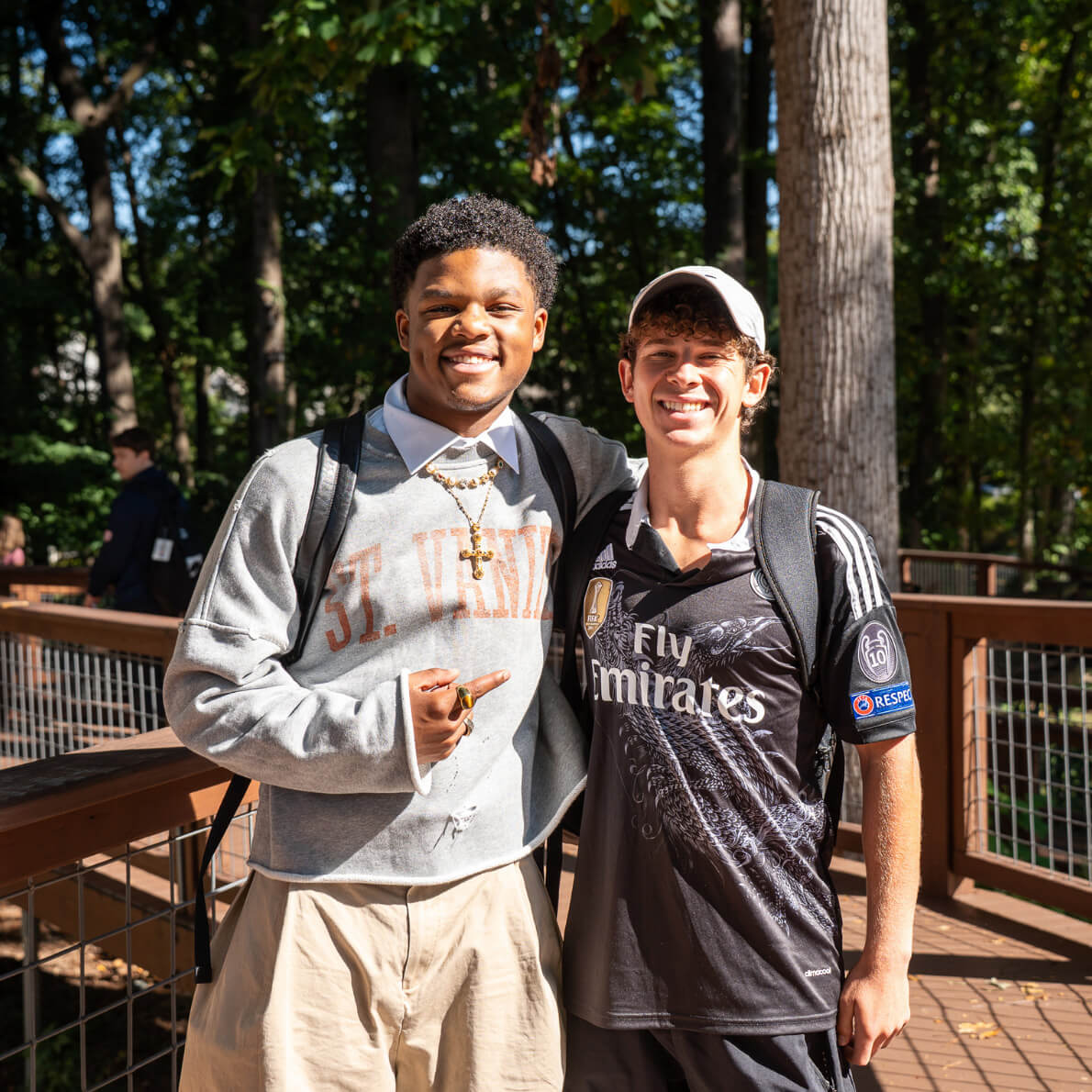 Two students embrace on the Schall Woodland Walk.