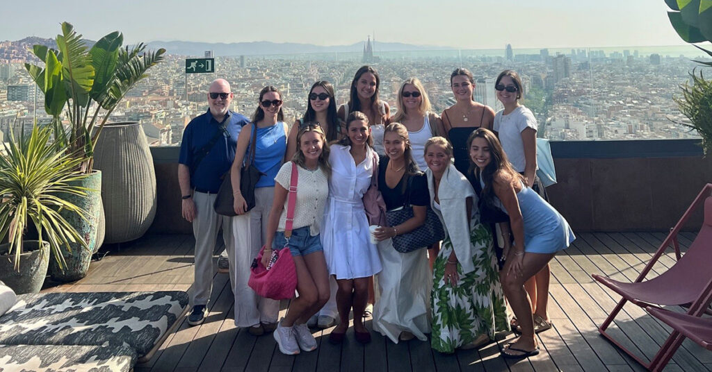 Dean Craft stands with students from summer Lead Abroad on a rooftop in Barcelona.
