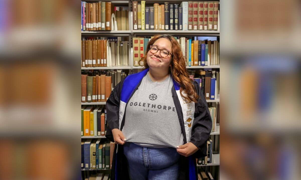 Valeri Cruz poses for a graduation photo in Philip Weltner Library.